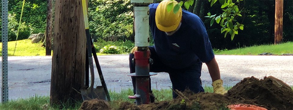 Drilling the hole for a new utility pole
